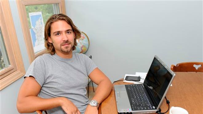 Underemployed man sits at computer
